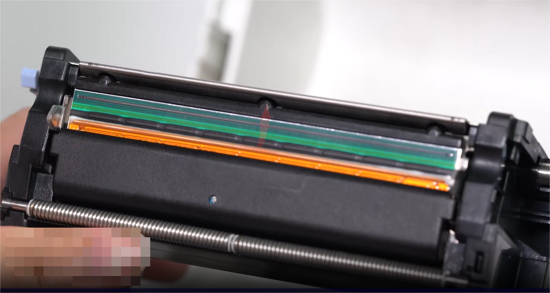 เอ close-up of a person carefully cleaning an electronic component with a swab.